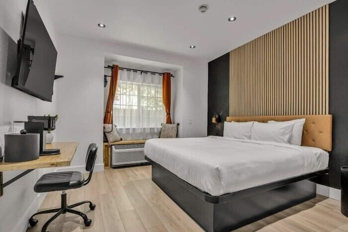 Premium bedding, desk, laptop workspace, blackout drapes