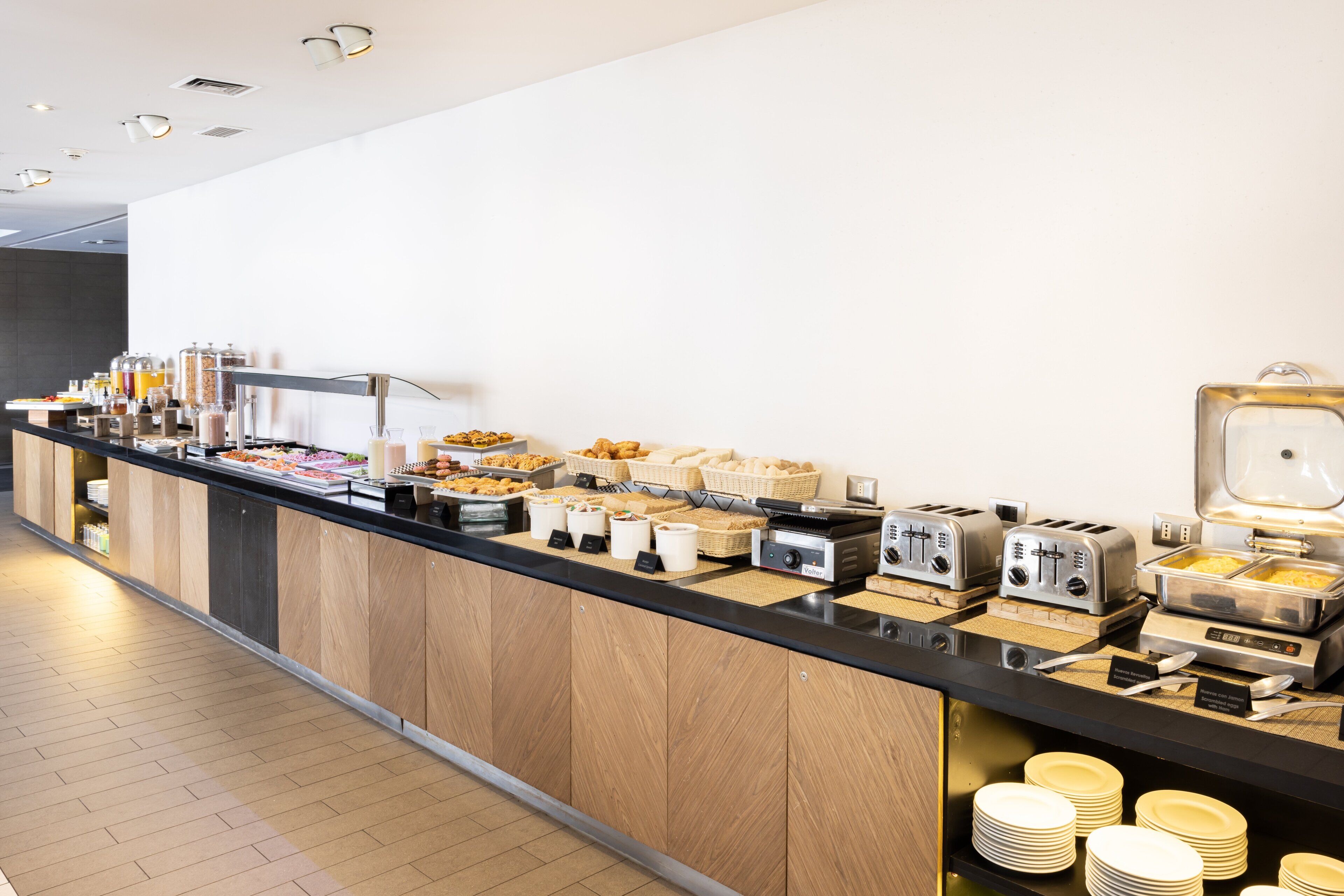 A buffet setup with various food items and appliances.