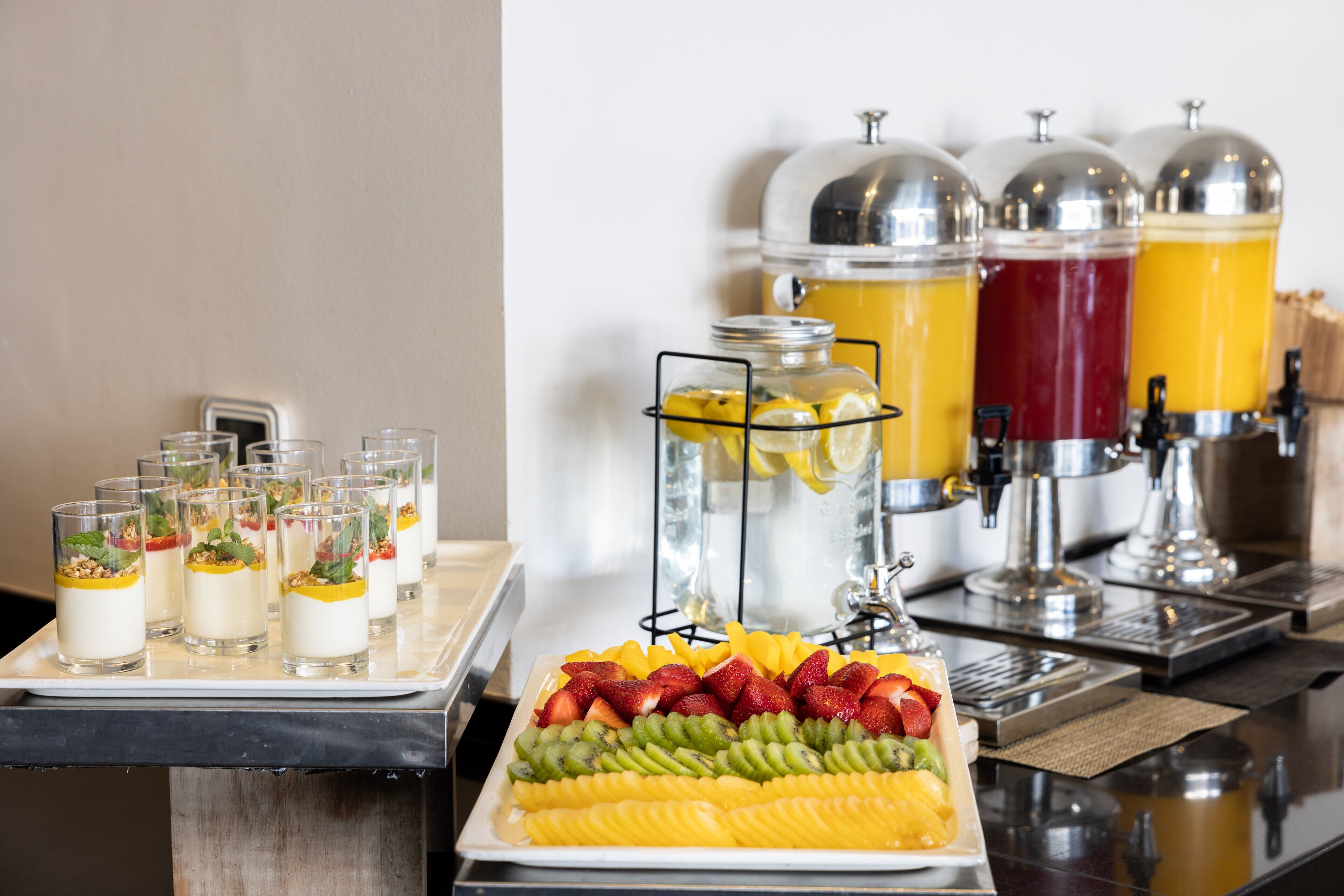 A buffet with various food items and beverages.