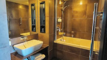 Un baño moderno con un lavamanos grande, espejo y cabina de ducha.