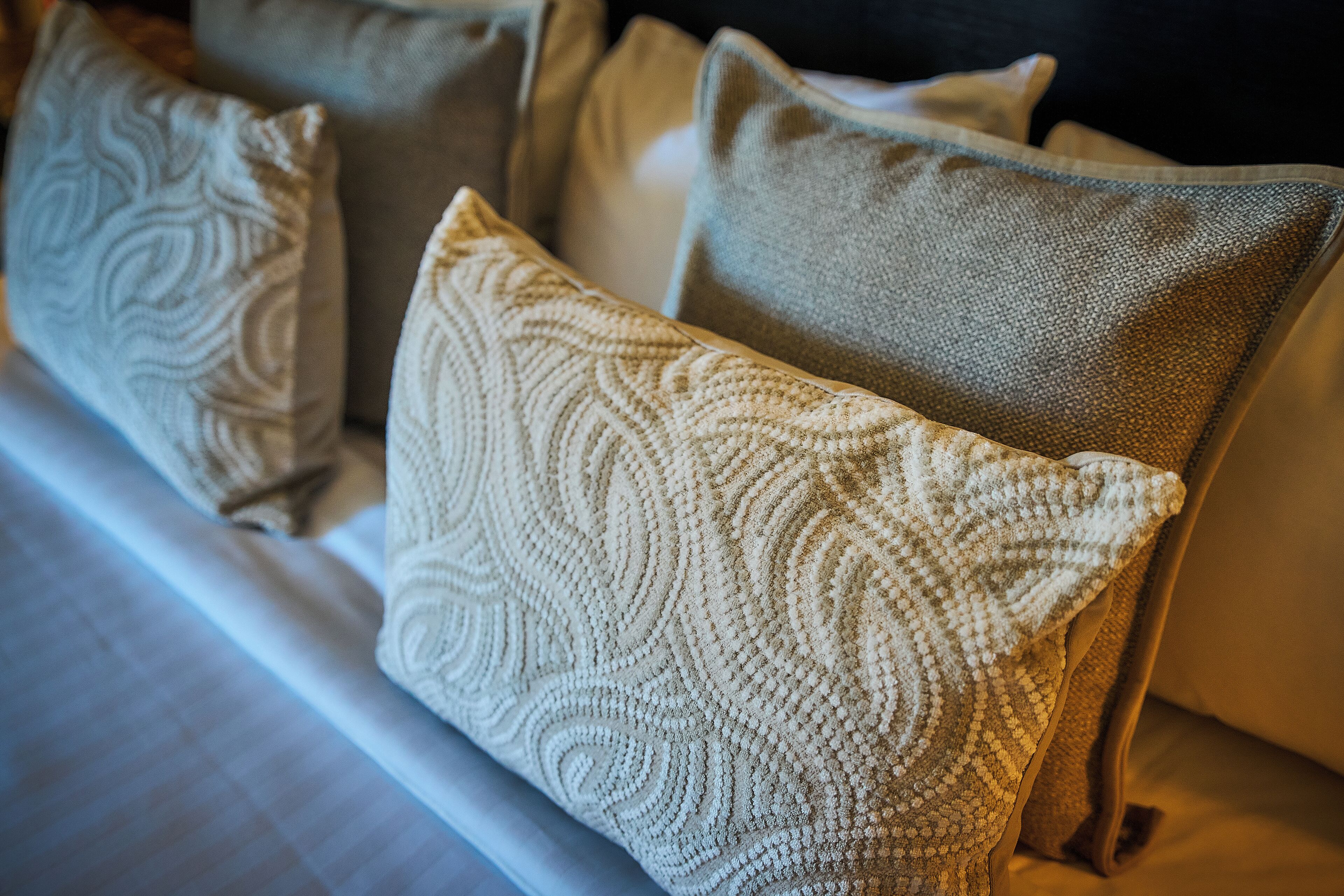 A close-up of a sofa with patterned cushions.
