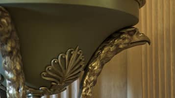 A close-up of a table with ornate metalwork and a decorative leaf pattern.