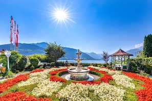 Stroll through the serene garden, surrounded by vibrant flowers and a tranquil lake view.