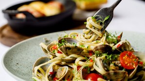 A plate of pasta with clams and cherry tomatoes. - Best Western Bristol North The Gables Hotel (Wotton-under-Edge)