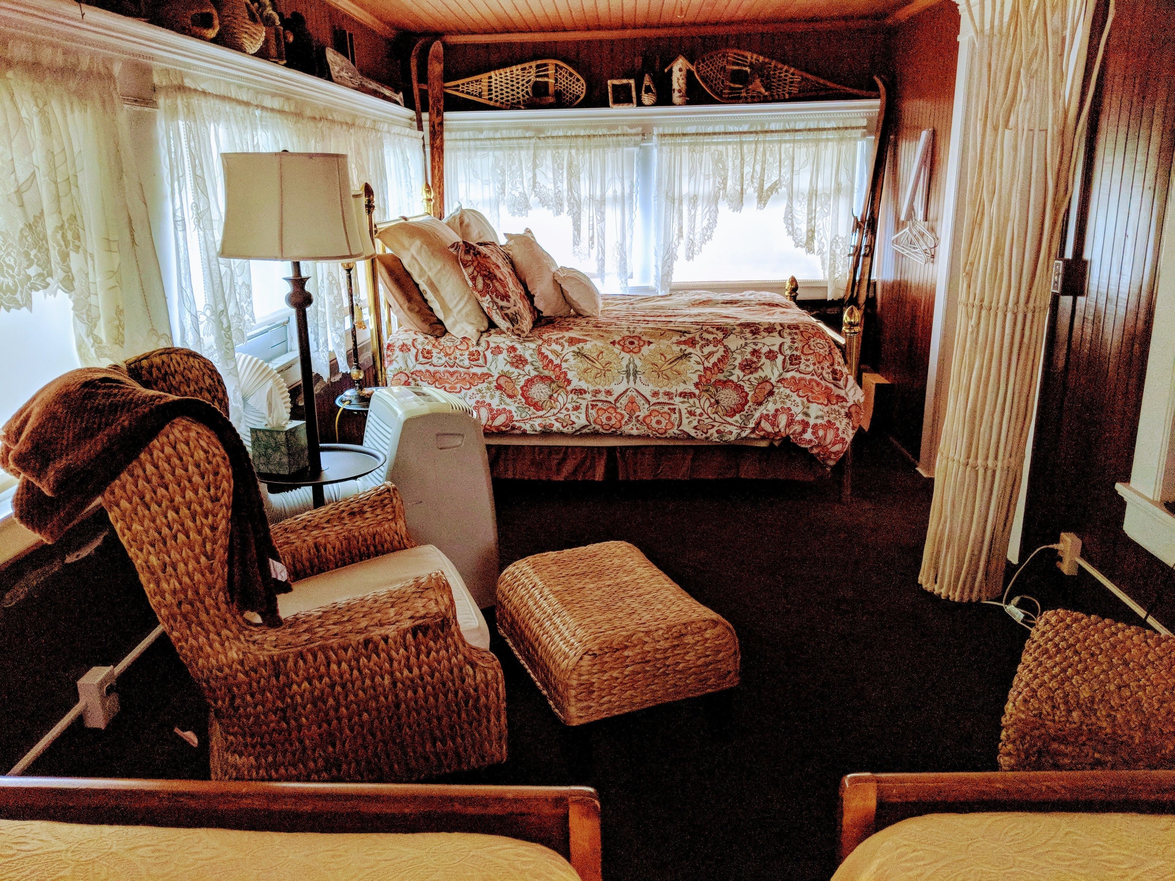 A cozy, compact bedroom with a bed, a chair, and a small table.