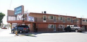 A two-story motel with a signboard advertising rooms and suites.