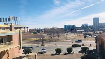 Un hotel con letrero, zona de estacionamiento y vista panorámica de la ciudad.