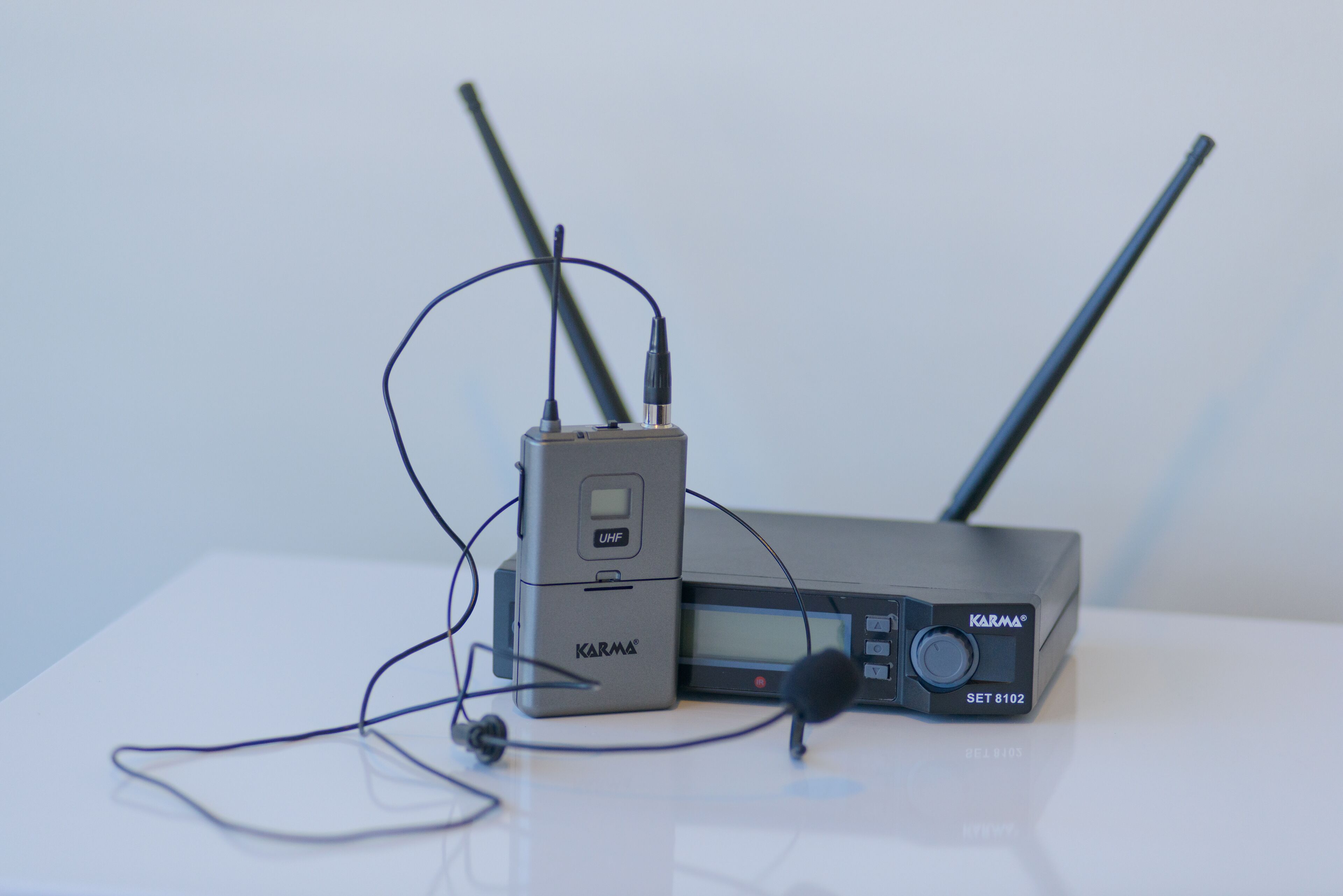 A device with antennas and a microphone, labeled "Karma" and "SET 8102".