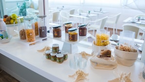A buffet table with various food items and condiments. - Hotel Cristallo Riccione (Riccione)