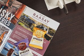 A brochure for the Isle of Raasay distillery, featuring a Butterscotch Crunch cookie and a bottle of whiskey.