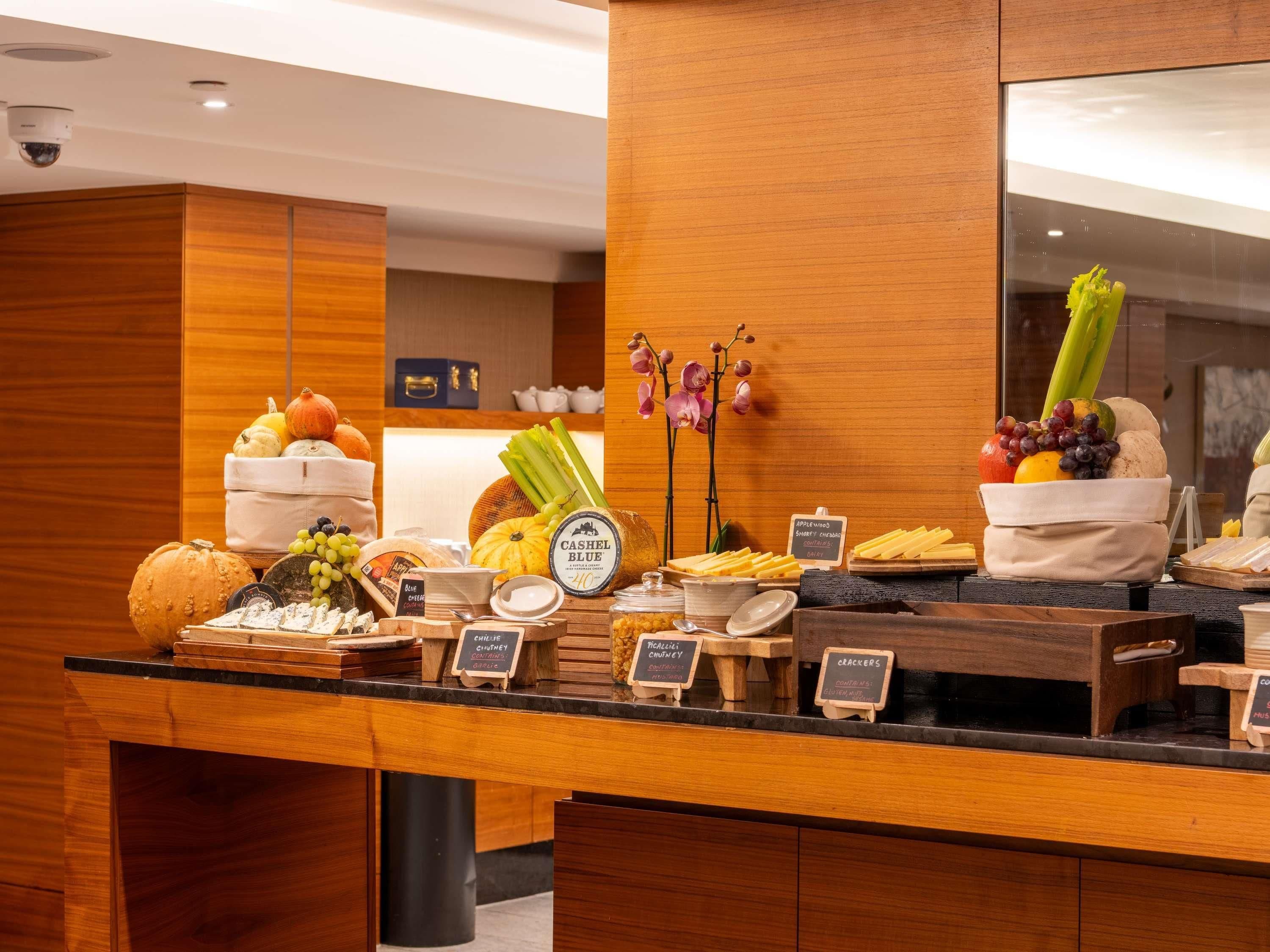 A buffet counter with various food items and labels.