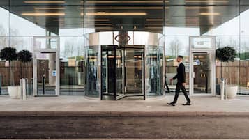 Enter through the revolving door into a welcoming space.