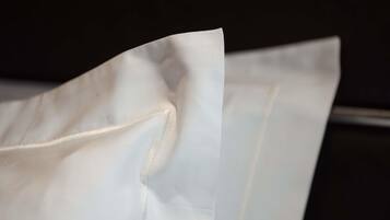 A white fabric with a visible seam and a folded edge.