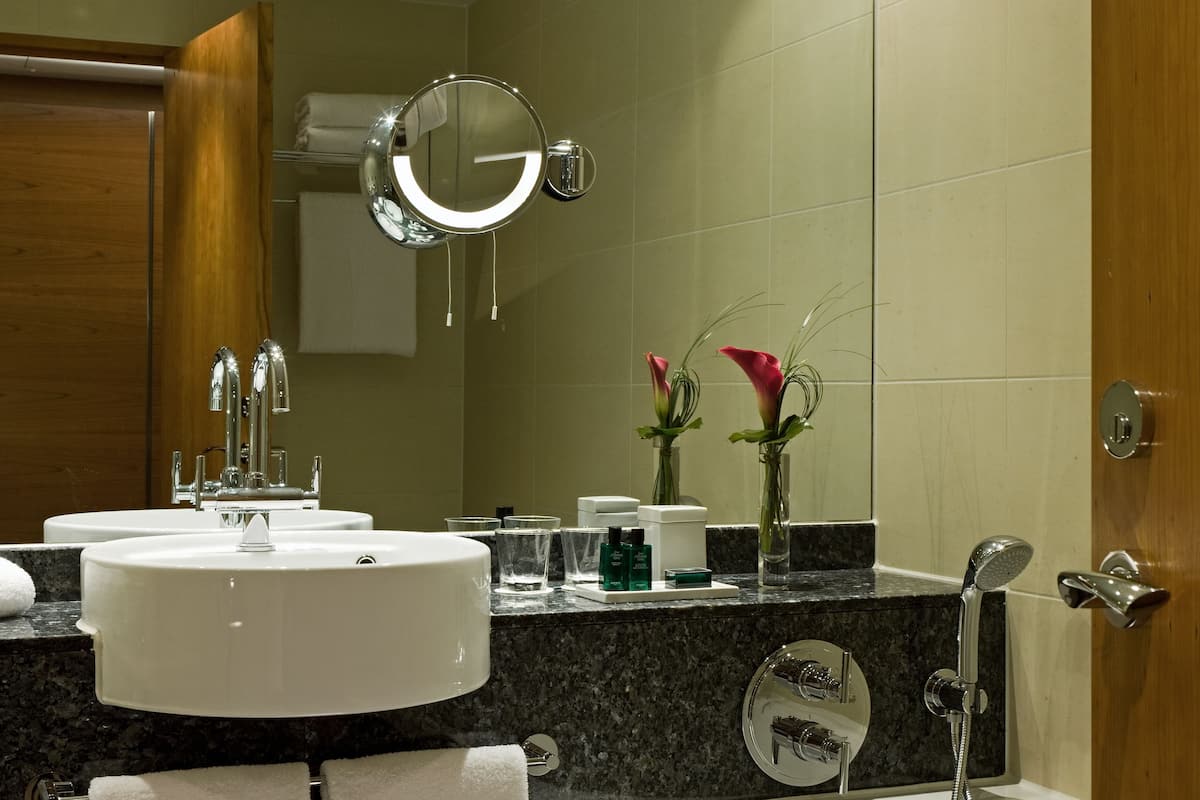 separate bathtub and shower, designer toiletries, hair dryer, bathrobes