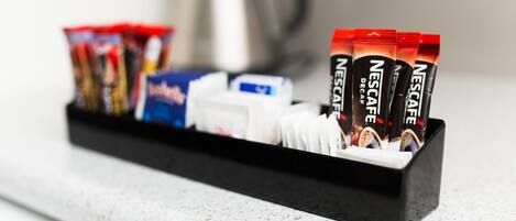 A coffee machine with a coffee pod holder containing various brands of coffee pods.