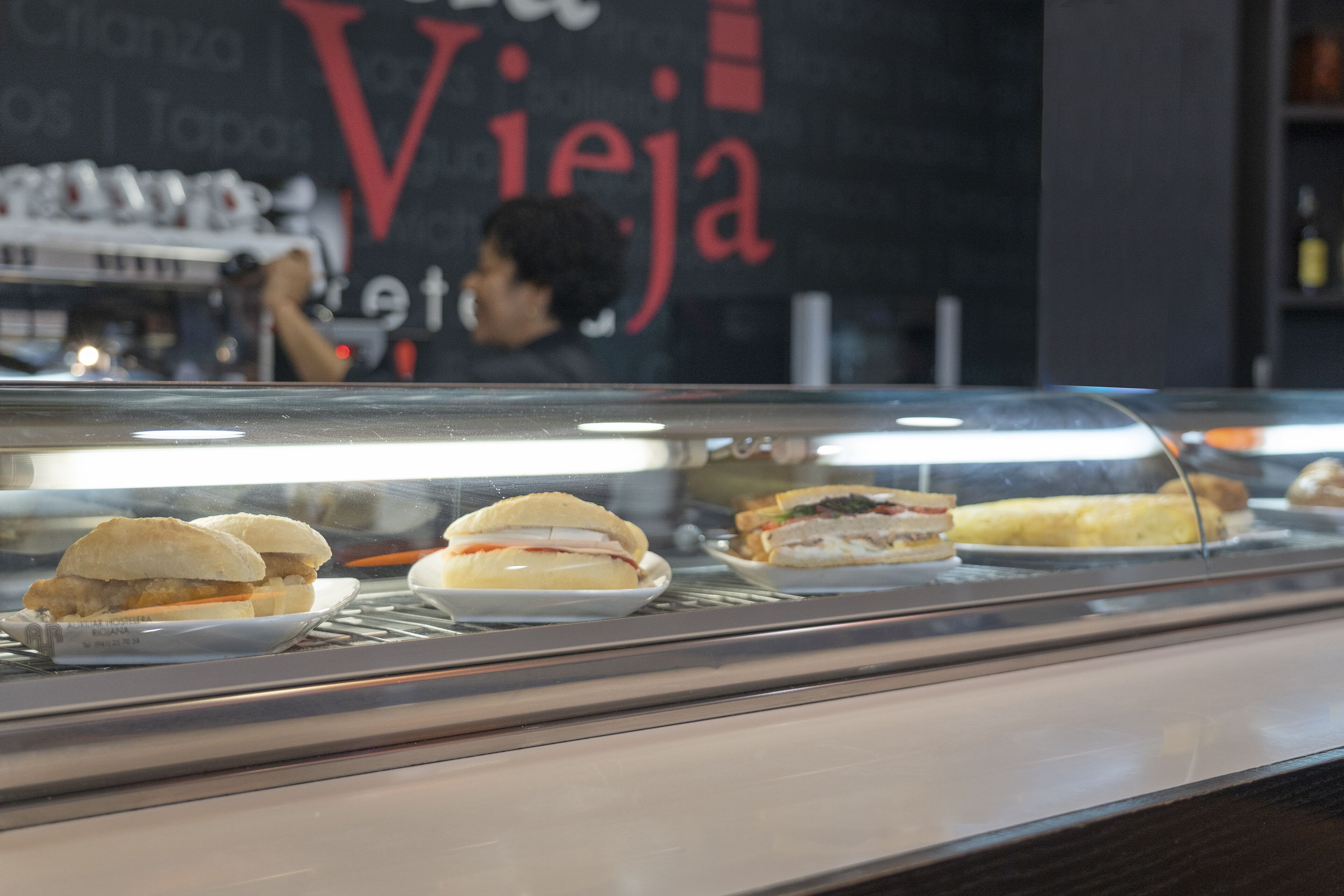 A sandwich display case with various sandwiches.