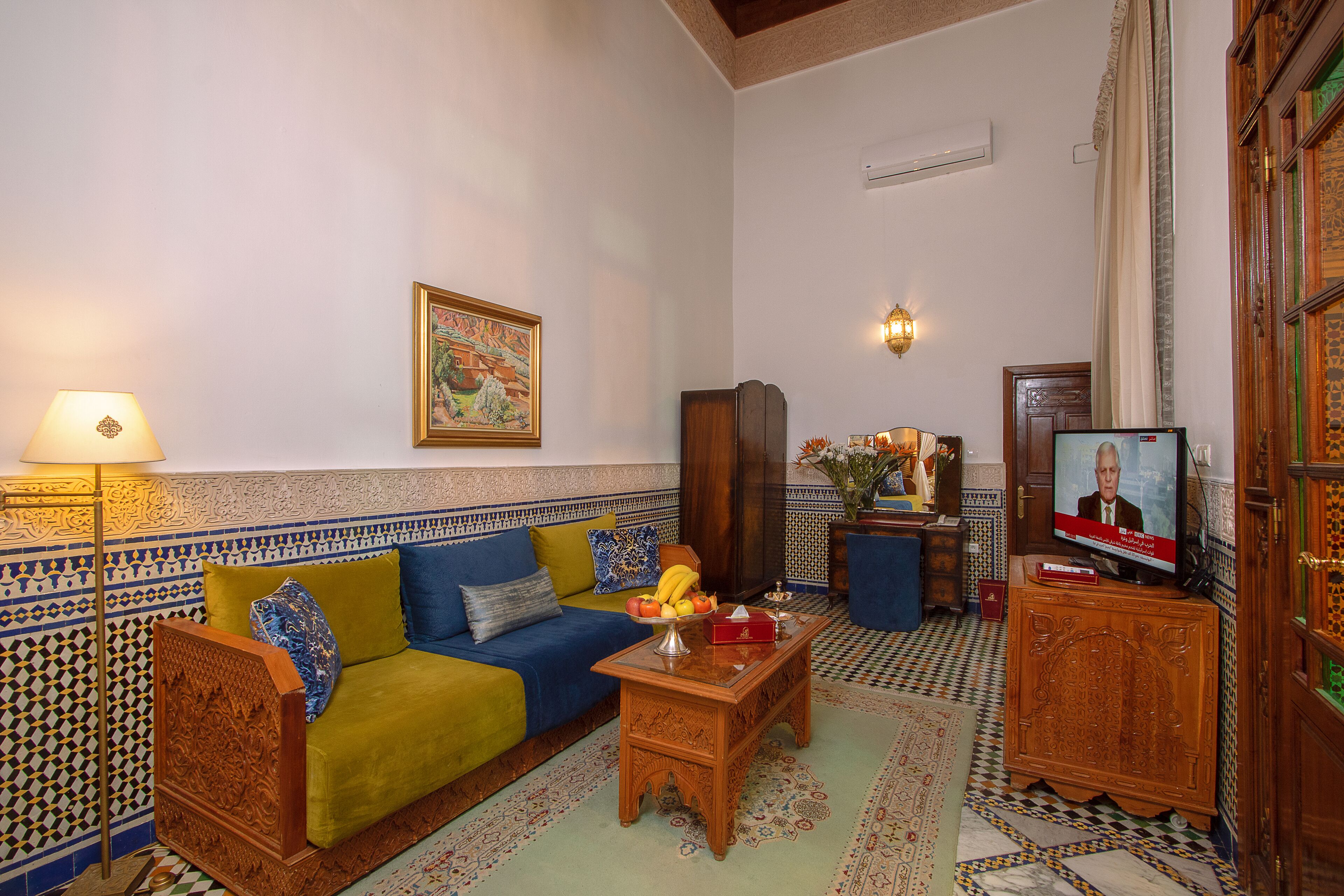 A living room with a sofa, coffee table, and television.