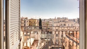 A balcony with a view of a cityscape, featuring buildings and a clear sky. - Hotel San Marco (Rome)