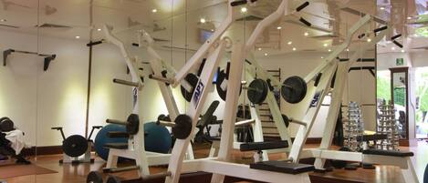 A gym with various exercise equipment, including weight machines and free weights.