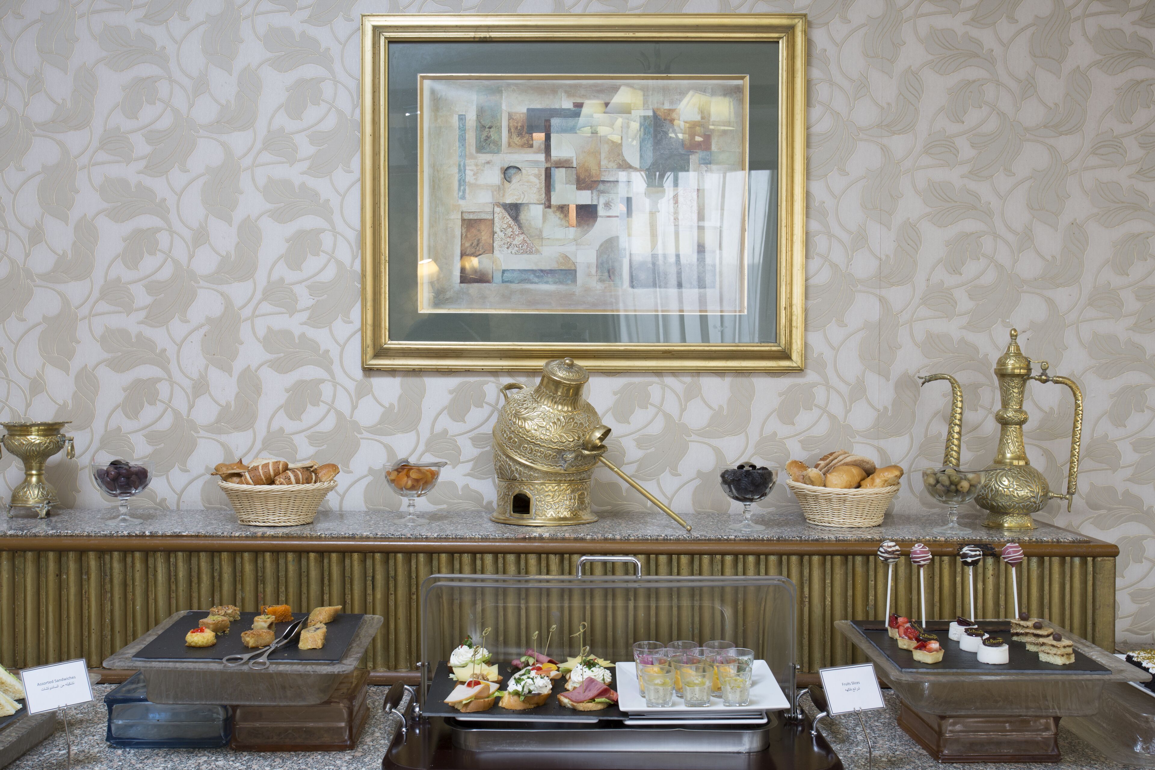 A buffet setup with various food items and decorative elements.