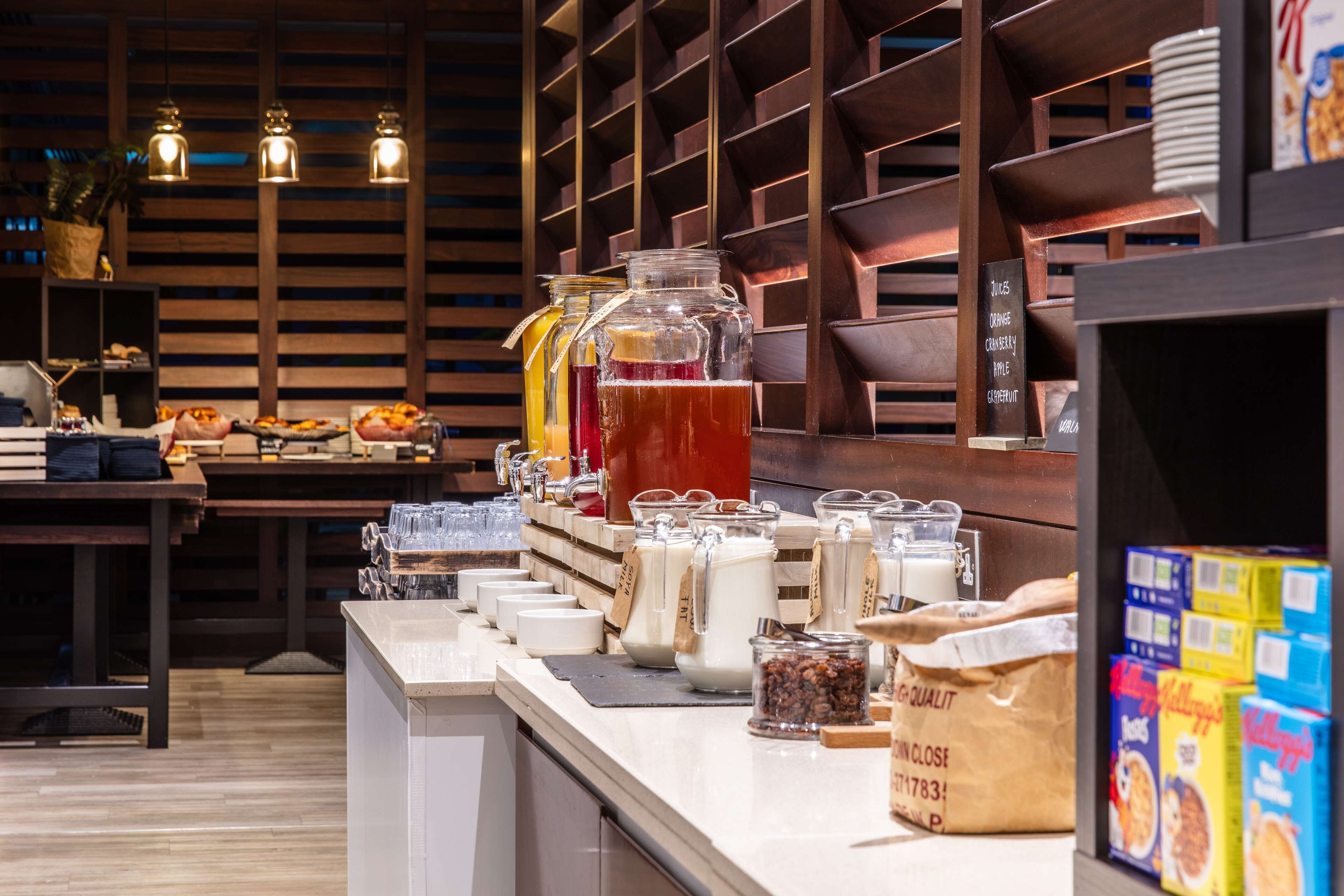 A buffet area with various food items and beverages.