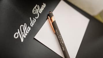 A black surface with a white piece of paper and a pen.