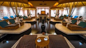 A spa area with multiple seating arrangements, a central water feature, and a reception desk. - Nexus Resort & Spa Karambunai (Kota Kinabalu)