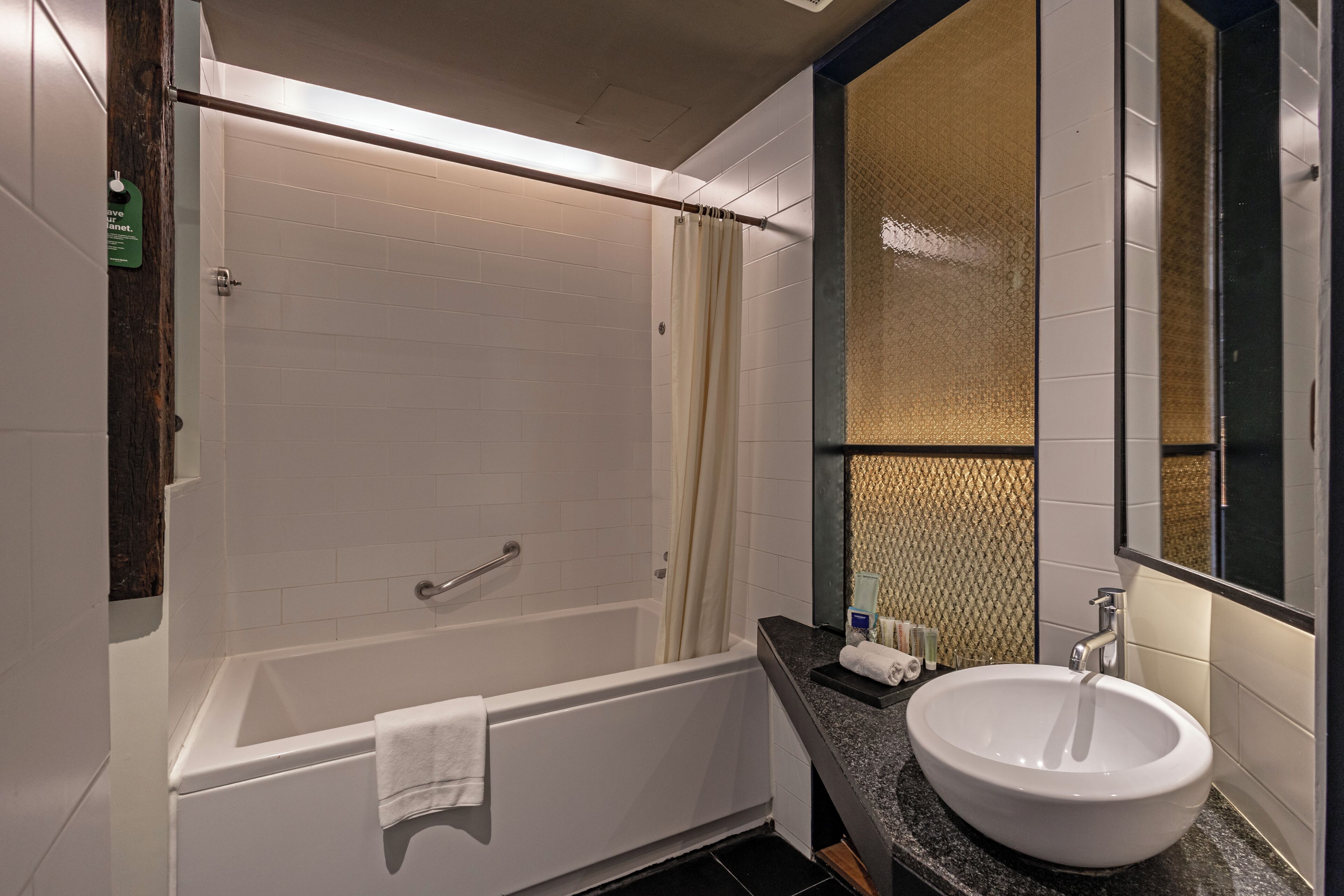 A modern bathroom with a bathtub, a sink, and a mirror.