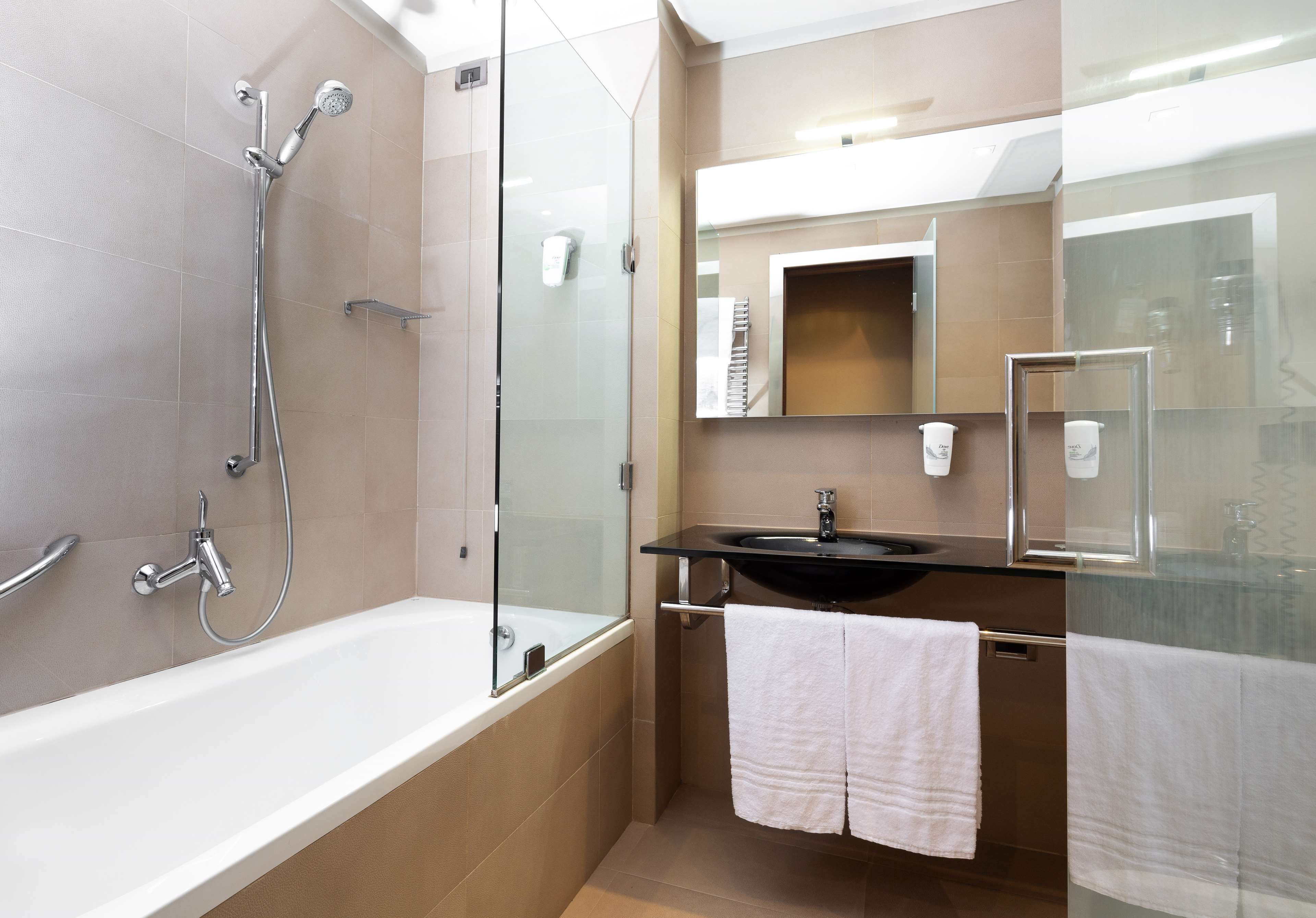 deep-soaking bathtub, rainfall showerhead, designer toiletries