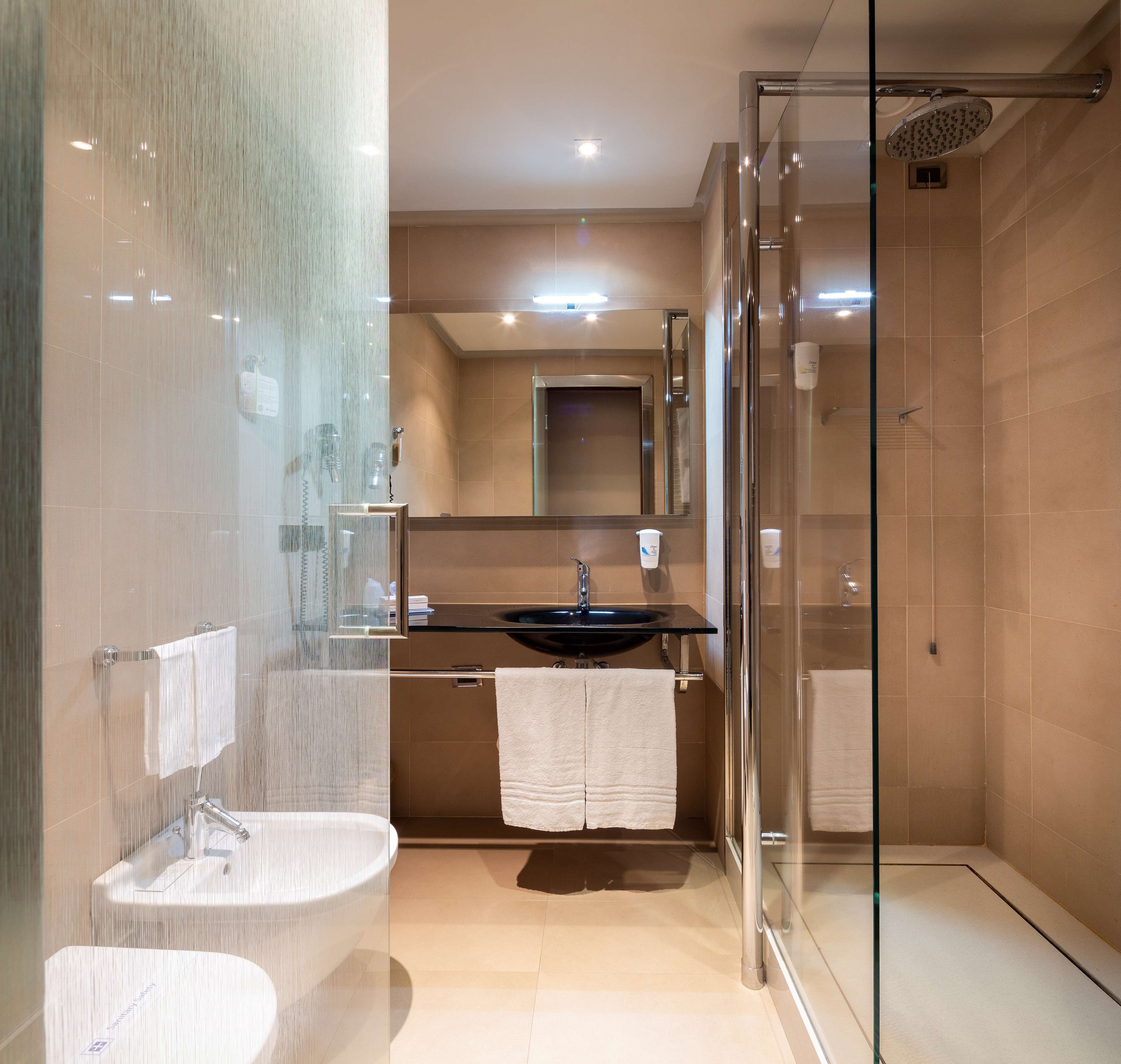 deep-soaking bathtub, rainfall showerhead, designer toiletries