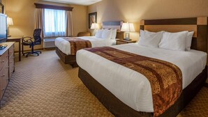 A hotel room with two beds, a desk, a chair, and a television. - Crandon Inn and Suites (Crandon)