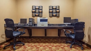 A conference room with two desks, each with a computer and a printer, and two black office chairs. - Crandon Inn and Suites (Crandon)