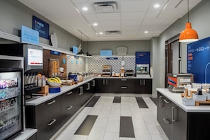 A modern breakfast area with a self-serve station, cereal, and bakery options. - Holiday Inn Express & Suites Yuma by IHG (Yuma)