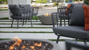 A patio area with outdoor seating and a fire feature. - The Rewind West Des Moines, Tapestry Collection by Hilton (West Des Moines)