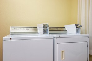 Two stacked washing machines with a control panel on top. - Holiday Inn Express Hotel & Suites El Dorado, Kansas by IHG (El Dorado)