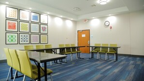 A conference room with a long table and chairs, a clock, and framed artwork on the wall. - Holiday Inn Express Hotel & Suites Texas City by IHG (Texas City)