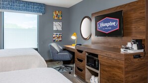 A hotel room with two beds, a desk with a lamp, a television, and artwork on the wall. - Hampton Inn & Suites Hopkinsville (Hopkinsville)