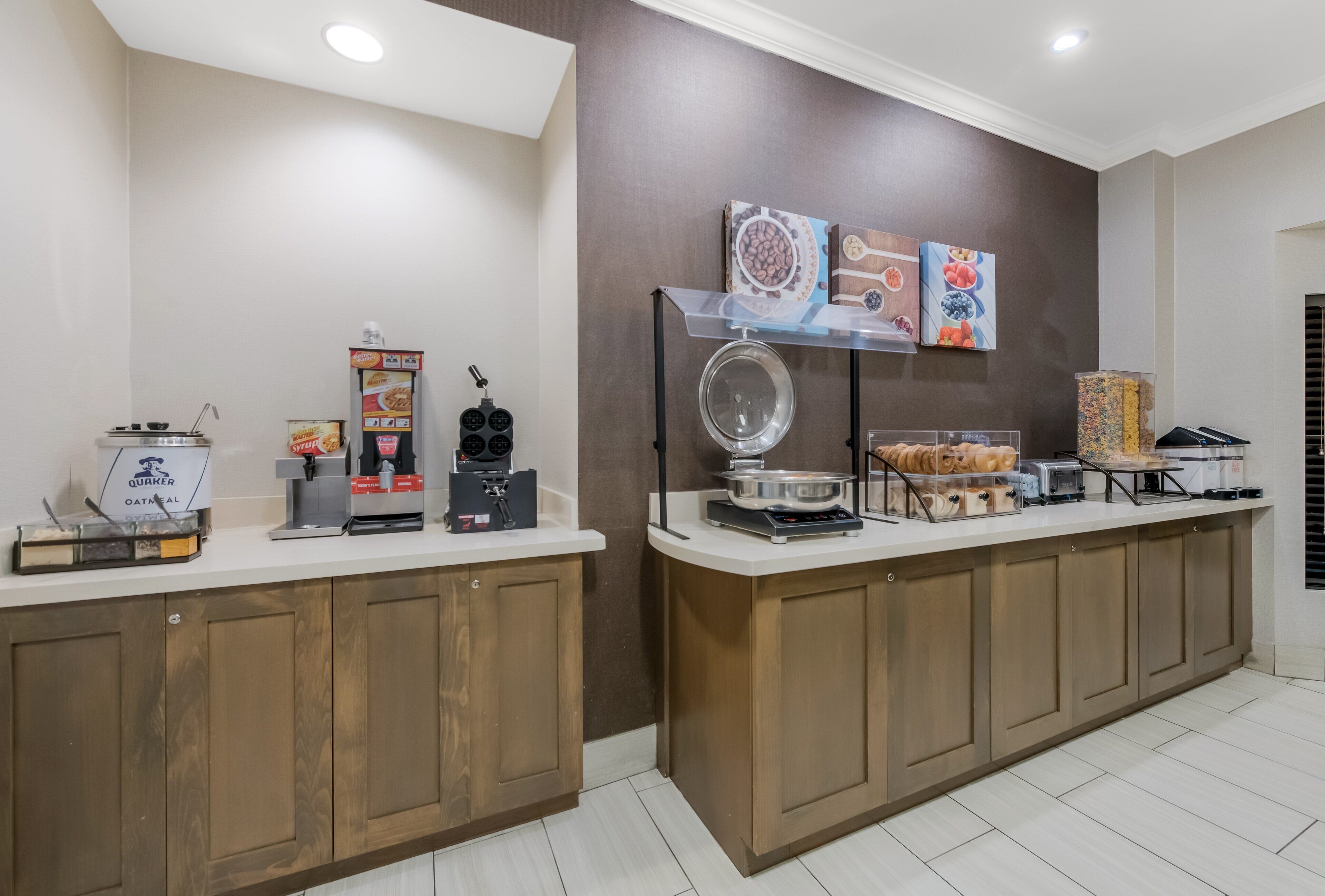 A breakfast bar with a coffee machine, toaster, and various food items.
