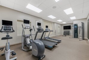 A gym with treadmills, elliptical machines, and a weight machine. - Staybridge Suites Chesapeake by IHG (Chesapeake)