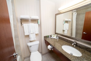 A bathroom with a toilet, sink, and towel rack.