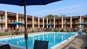 A swimming pool with a brick building in the background.