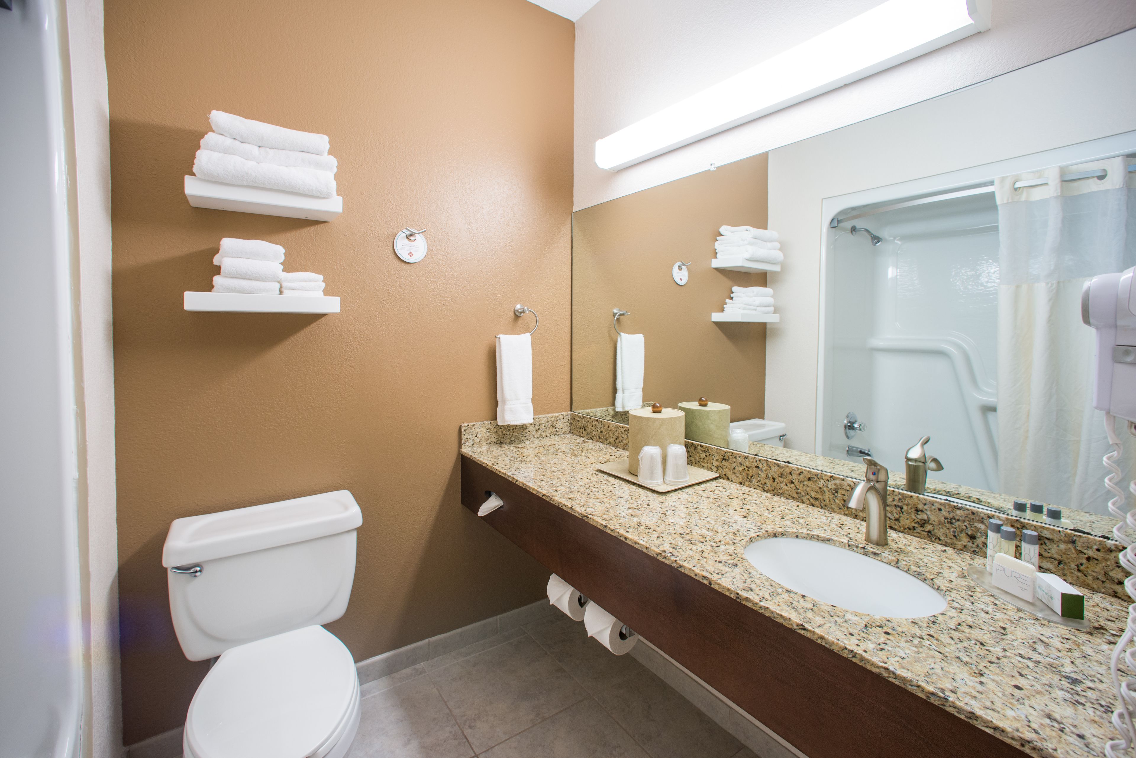 designer toiletries, hair dryer, towels