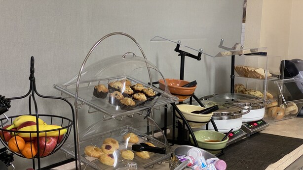 A buffet setup with various food items and serving utensils. - Northfield Inn, Suites & Conference Center (Springfield)