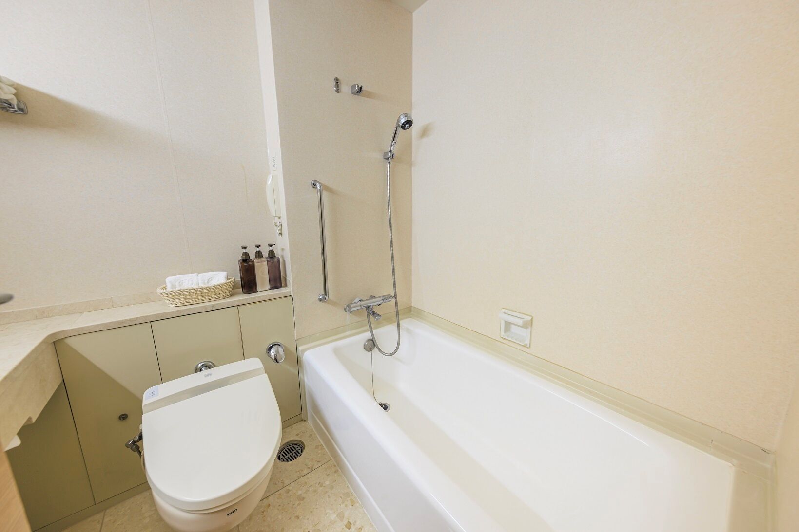 A bathroom with a toilet, a bathtub, and a shower.