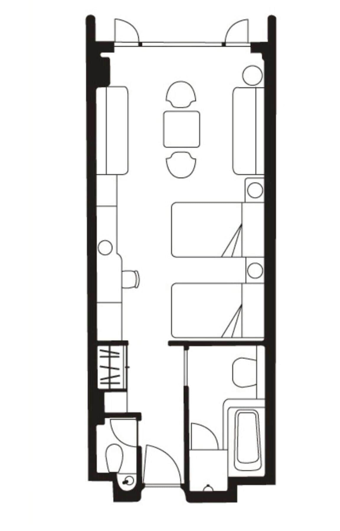 A floor plan of a hotel room with a bed, a desk, a chair, a bathroom, and a small sitting area.