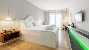 A modern hotel room with a large bed, bedside tables, a desk, and a television. - Beyond Hotel - Boutique Class - Special Class (Izmir)