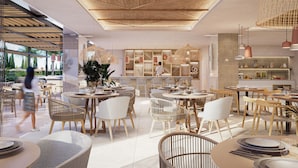 A modern restaurant with open seating, a central bar area, and a view of the outdoors.