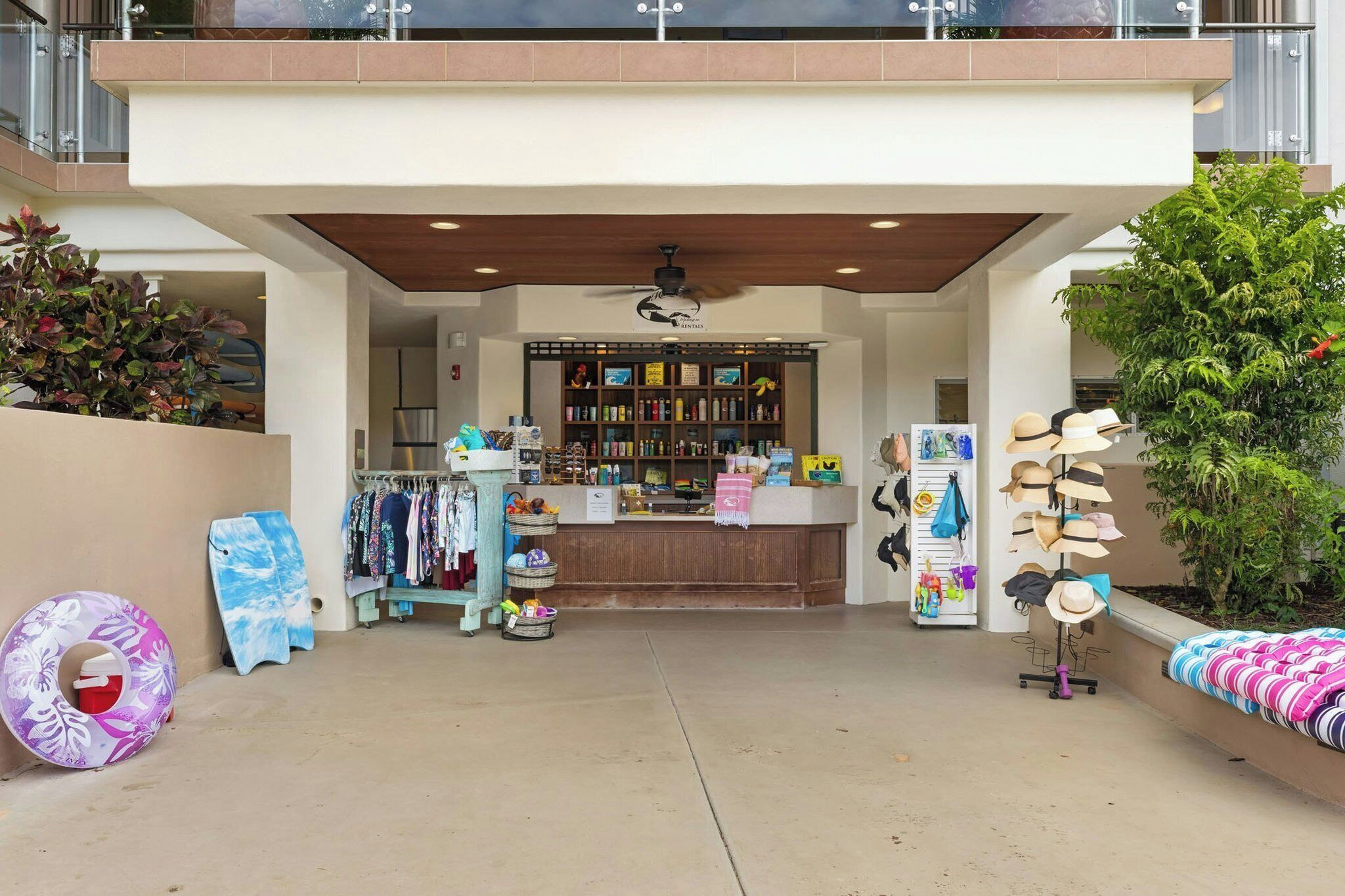 A storefront with a variety of items on display including hats, clothing, and accessories.