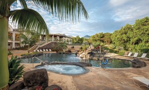 A resort pool with a hot tub, lounge chairs, and a staircase leading to a building. - Club Wyndham Bali Hai Villas (Princeville)