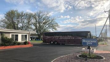Um ônibus estacionado em frente a um edifício com uma placa que diz 'Rodeway Inn'.